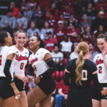 Nebraska women's college volleyball team celebrate point.