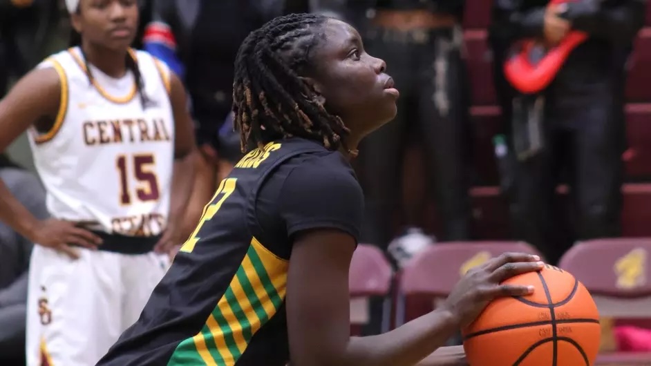 Kentucky State University women's basketball center Amina Seck shoots a ball on the women's college basketball court.